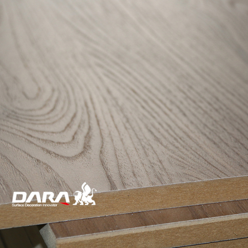 What distinguishes MDF from melamine board?